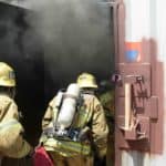 Firefighters entering smoke filled training center