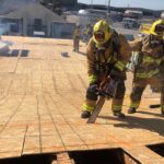 Firefighters on training cutting a flat roof