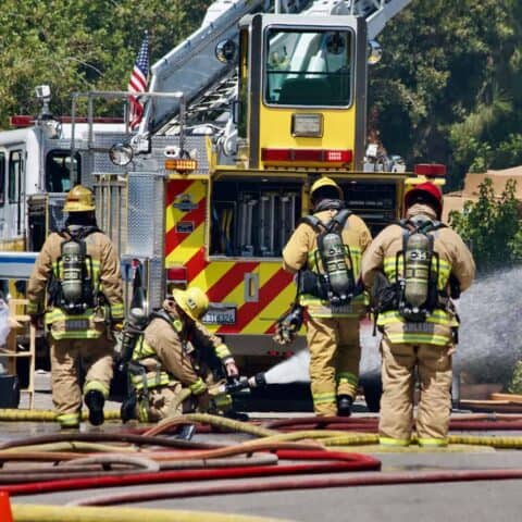 Firefighters behind fire engine